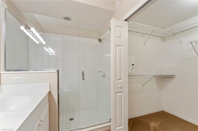 Full bathroom with baseboards, vanity, a spacious closet, and a shower stall | Image 26