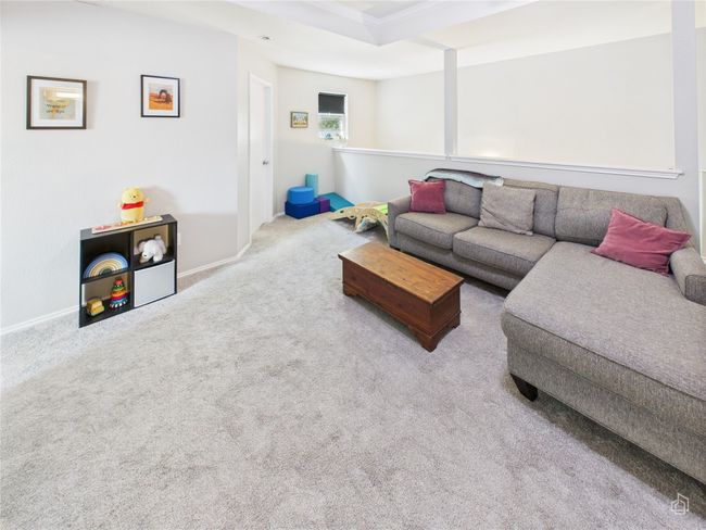 Carpeted living room featuring baseboards and crown molding | Image 18
