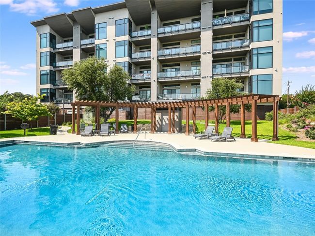 The Waterfall pool comes with lawn chairs, expansive pergola, cabana bathroom, and grills. | Image 19