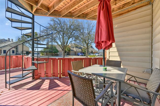 Wooden terrace featuring outdoor dining space and a residential view | Image 26