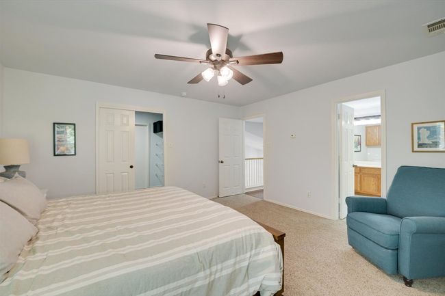 Bedroom with carpet, a ceiling fan, and connected bathroom | Image 11