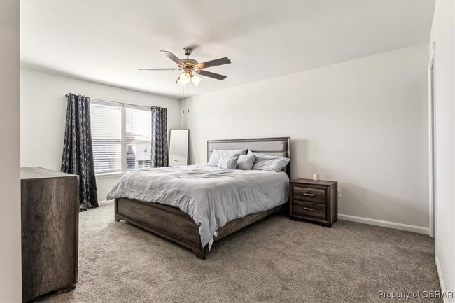 Carpeted bedroom featuring baseboards and ceiling fan | Image 14