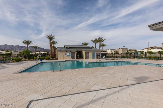 Community pool with a patio and fence | Image 4