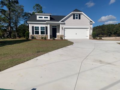 Craftsman-style house featuring a front lawn and a garage | Image 1