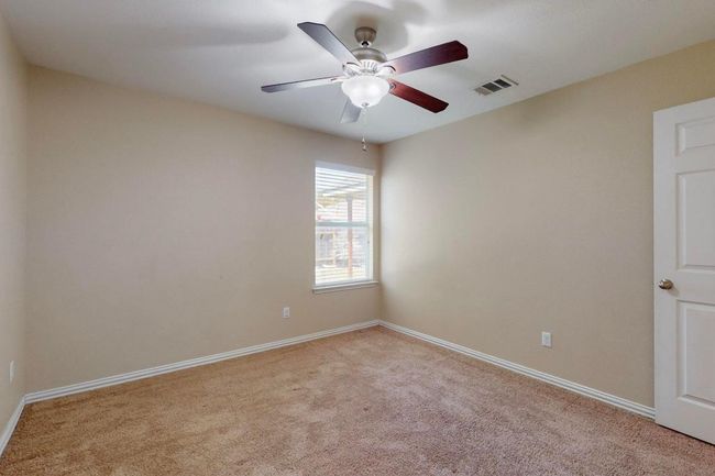 Secondary bedrooms on opposite sides of the hall bathroom . | Image 29