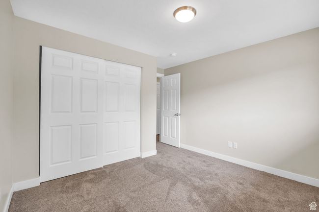 Unfurnished bedroom featuring a closet, baseboards, and carpet | Image 18