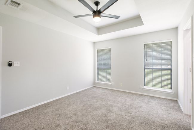 Spare room featuring carpet, healthy amount of natural light, and ceiling fan | Image 21