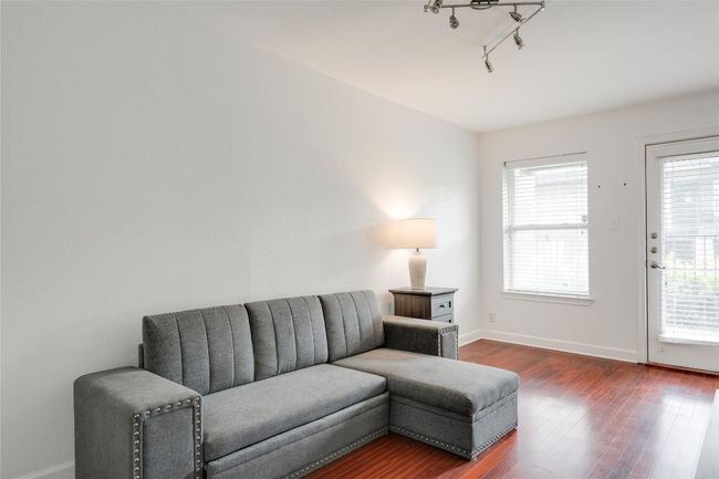 Living room featuring baseboards and dark wood-style floors | Image 30