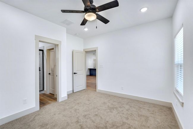 Unfurnished bedroom with carpet, visible vents, baseboards, and a ceiling fan | Image 16