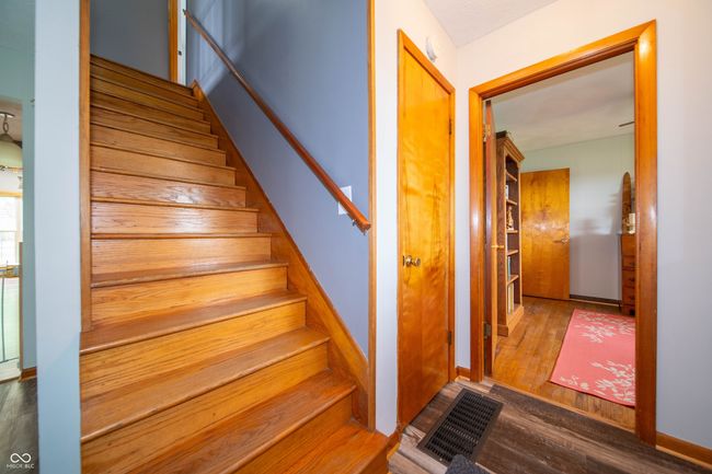 stairs with wood finished floors and baseboards | Image 8