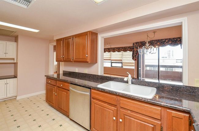 The kitchen overlooks the dining and living areas. | Image 11