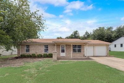 Ranch-style home featuring a garage and a front lawn | Image 3