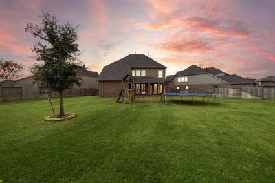 Picturesque Sunset amplifying how Spacious of a backyard! Very well maintained lawn with enought room for a pool, outdoor kitchen and there will still be plenty of yard. | Image 1