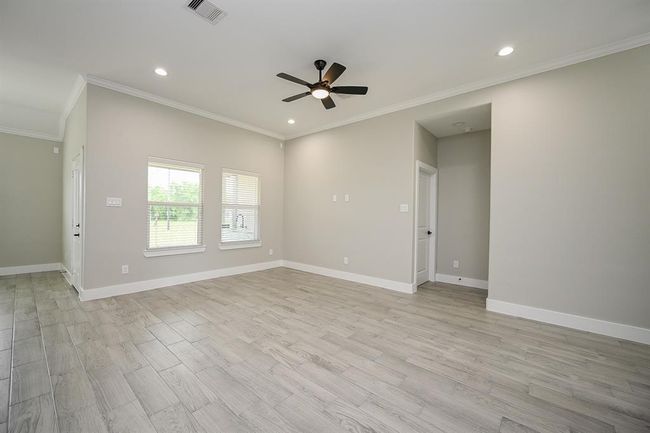Come Home & Enjoy This Spacious Living Room That Looks Out To The Backyard With A Ceiling Fan For An Inside Breeze To Keep Cool | Image 7