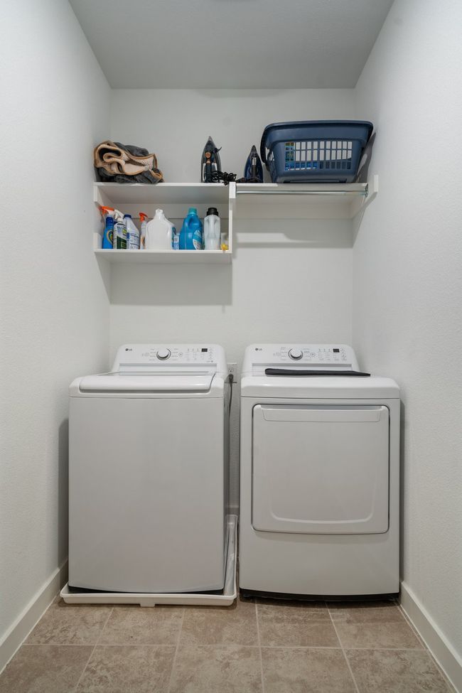 Laundry area with washing machine and clothes dryer and baseboards | Image 27