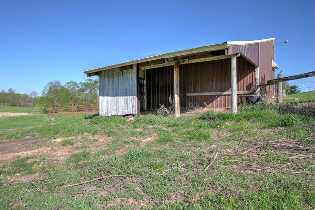 Partially enclosed attached overhang on back of barn. | Image 42