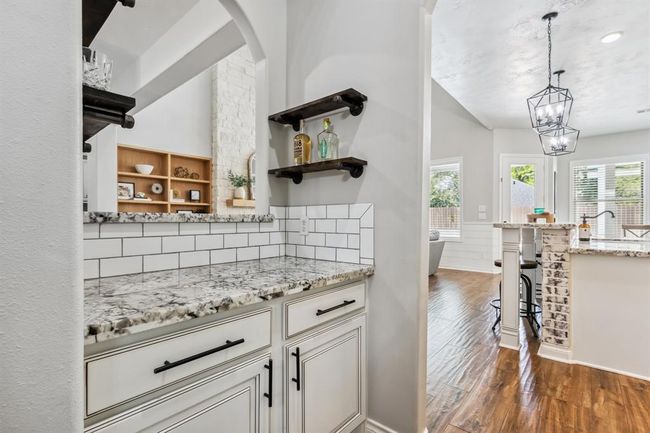 Step into the butler's pantry, which includes a handy peek-through opening. | Image 9