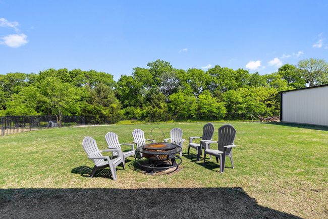 View of yard featuring fence and an outdoor fire pit | Image 29