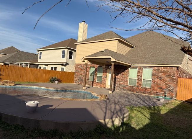 Back side view of beautiful home with great swimming pool. | Image 30