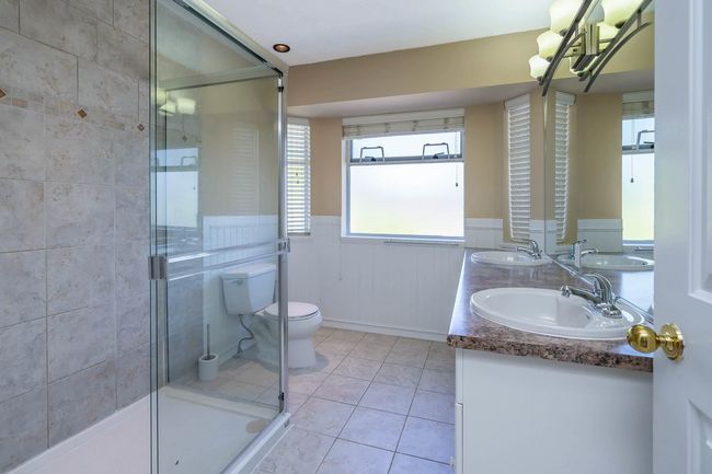 Bathroom featuring a stall shower, toilet, and a sink | Image 22