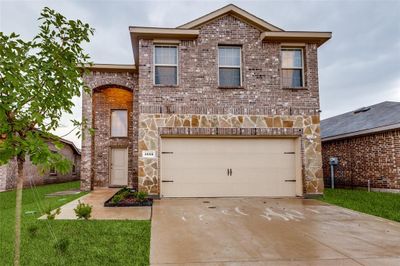 Front of property featuring a front lawn and a garage | Image 1