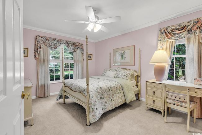 Bedroom featuring light carpet, ornamental molding, and ceiling fan | Image 16