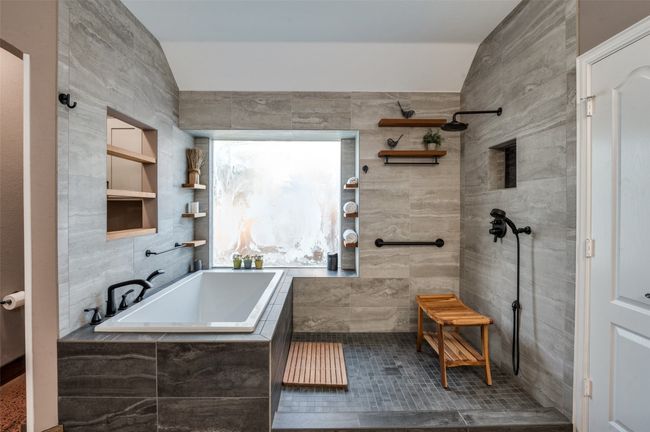 Primary bath with soaking tub, open shower, teak shelves, numerous decorator touches | Image 26