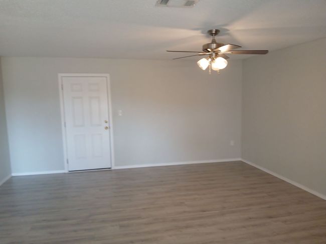 Spare room with hardwood / wood-style flooring and ceiling fan | Image 11
