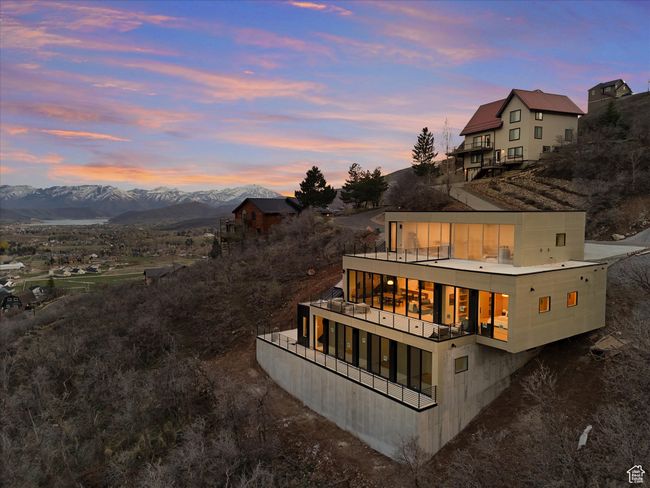 Back of property at dusk featuring a balcony and a mountain view | Image 34
