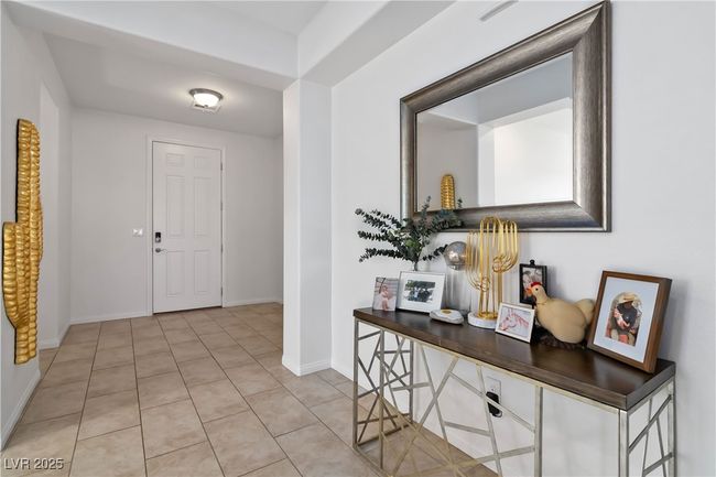 Foyer entrance with light tile patterned floors and baseboards | Image 12