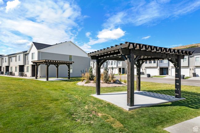 View of home's community featuring a yard, a pergola, and a residential view | Image 33