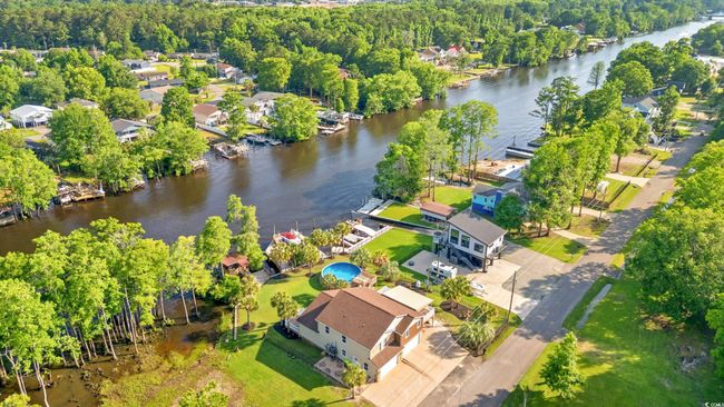 Aerial view of property's location featuring a nearby body of water and nearby suburban area | Image 39