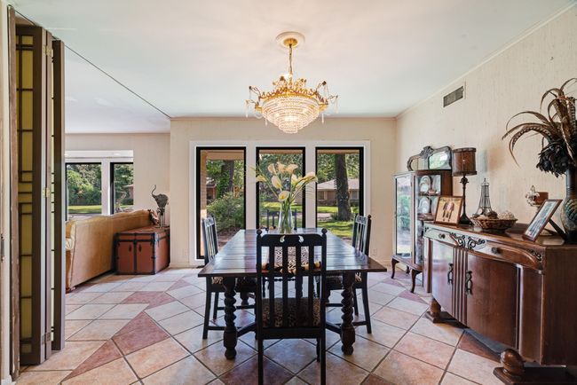 Dining area featuring a chandelier, healthy amount of natural light, and light tile patterned floors | Image 4