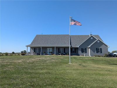 View of front facade featuring a porch and a front lawn | Image 1