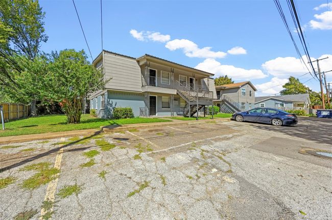 View of front facade featuring stairway and uncovered parking | Image 19