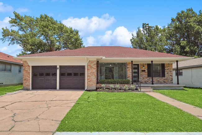 Single story home with a front lawn, covered porch, brick siding, concrete driveway, and an attached garage | Image 33
