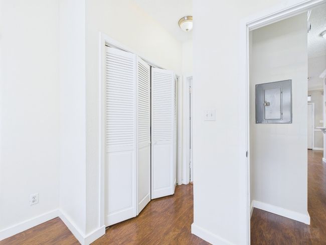Hall with dark wood-type flooring and baseboards | Image 22