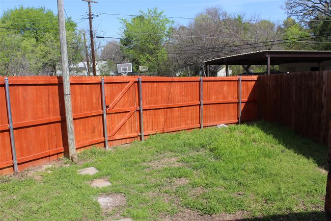 View of fenced backyard | Image 14