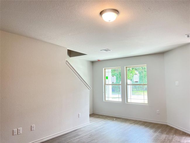 Brighten your space with natural light streaming through the windows by the staircase. | Image 8