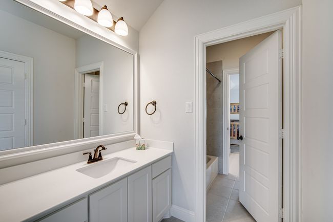 Jack and Jill featuring tile patterned floors, vanity, and tiled shower / bath | Image 29