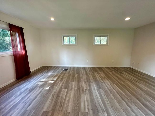 Spare room featuring hardwood / wood-style flooring | Image 7