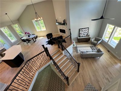 Living room with hardwood / wood-style floors, plenty of natural light, and high vaulted ceiling | Image 3