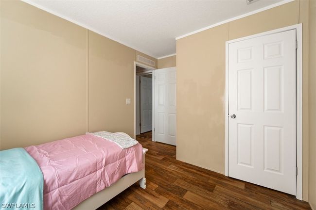 Bedroom featuring ornamental molding and dark hardwood / wood-style flooring | Image 18