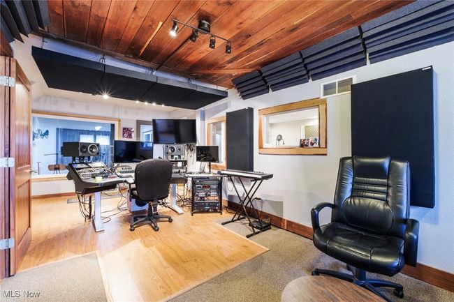 Office with visible vents, track lighting, baseboards, wooden ceiling, and wood finished floors | Image 7