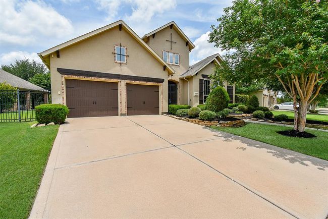 Double wide driveway to the 3 car tandem garage with epoxy floors! | Image 4