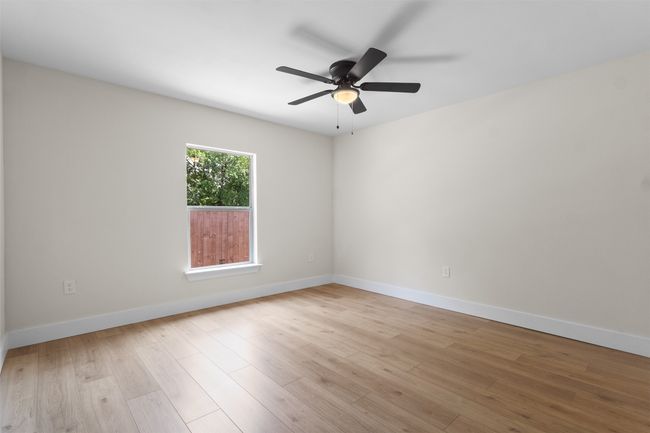 Empty room featuring a ceiling fan and light wood-style flooring | Image 11