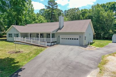 Single story home with a porch, a garage, and a front yard | Image 2