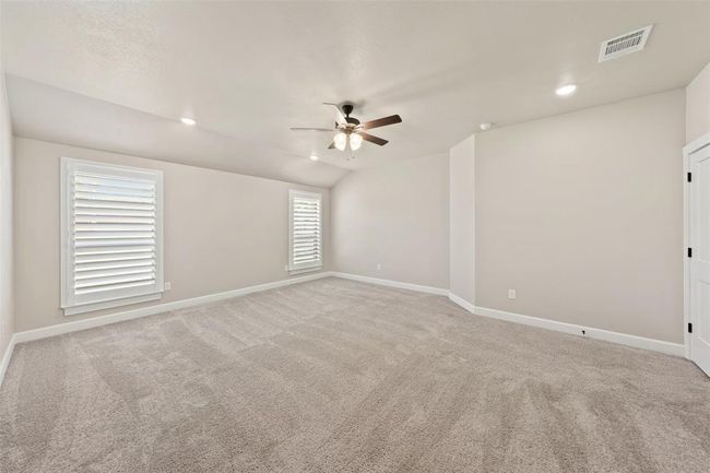 Spacious primary bedroom with ceiling fan | Image 27
