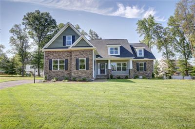 Craftsman-style home with a front yard and covered porch | Image 1