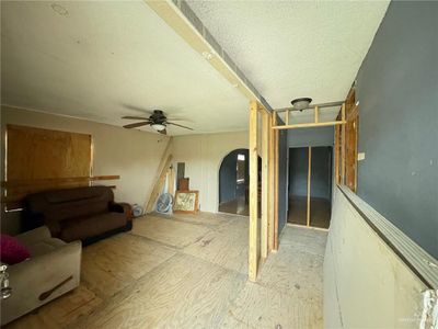 Living room featuring ceiling fan and a textured ceiling | Image 3